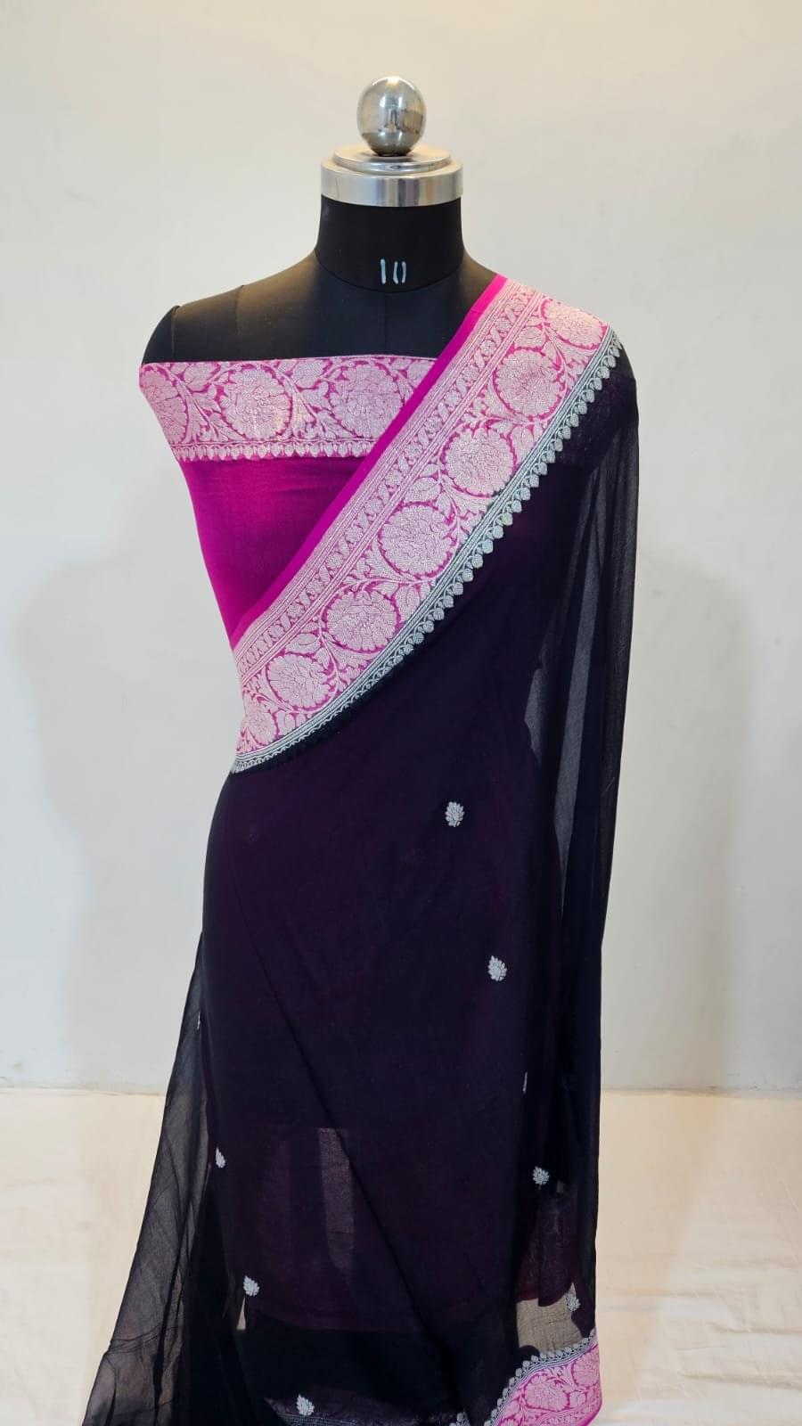 Nisha-Kiran:"Ray of light in the night sky"—perfectly capturing the contrast of the deep black chiffon body and the radiant magenta pallu.